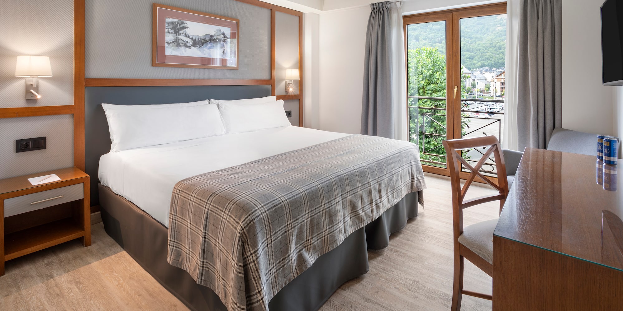 a room with a bed and a table and chairs