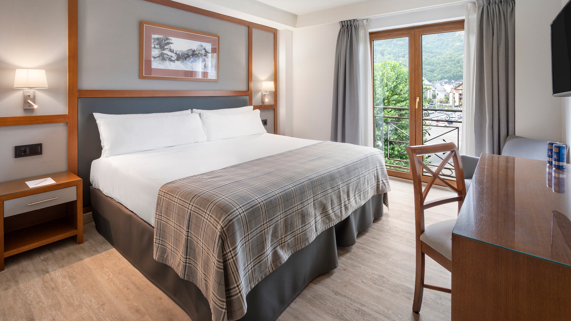 a room with a bed and a table and chairs