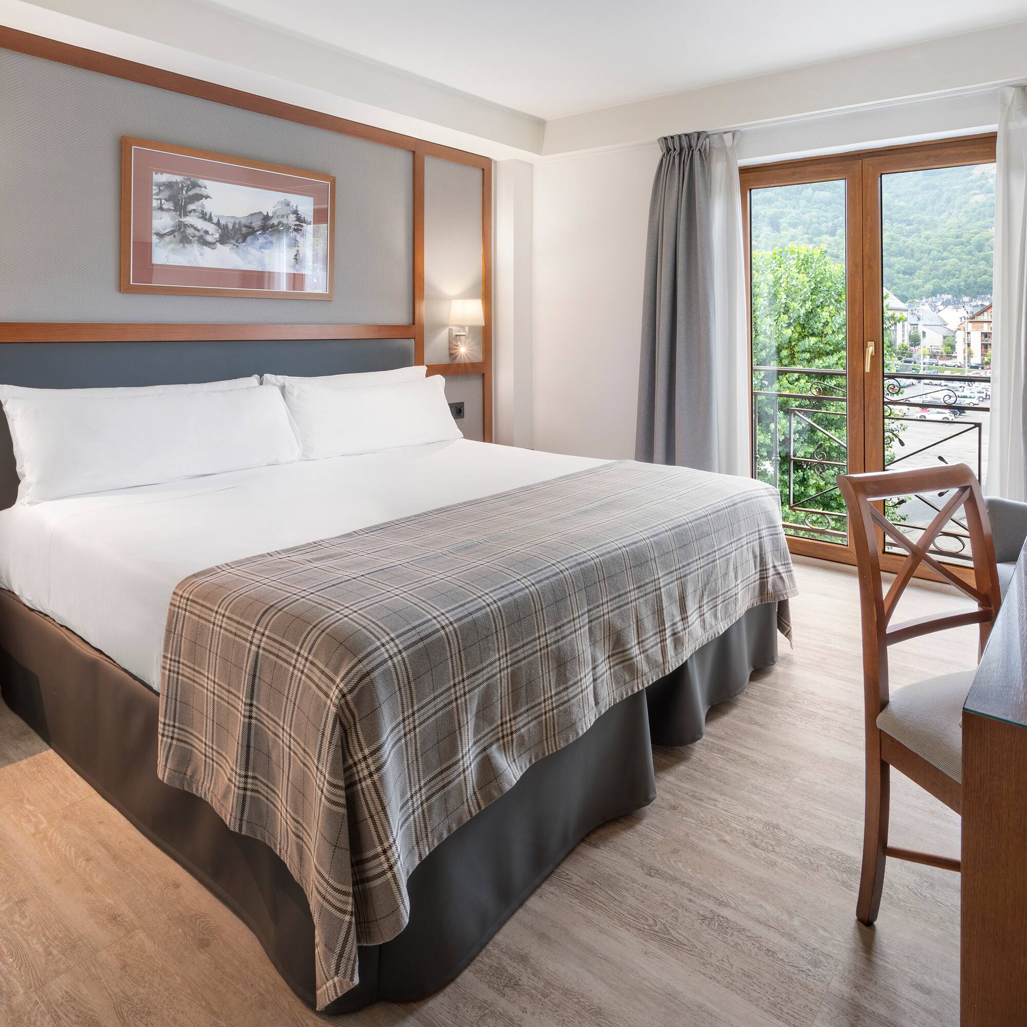 a room with a bed and a table and chairs