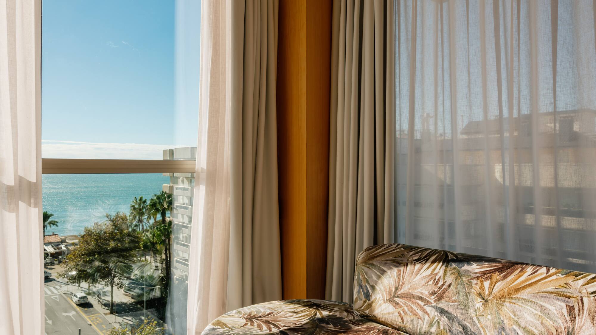 a couch in a room with a view of the ocean