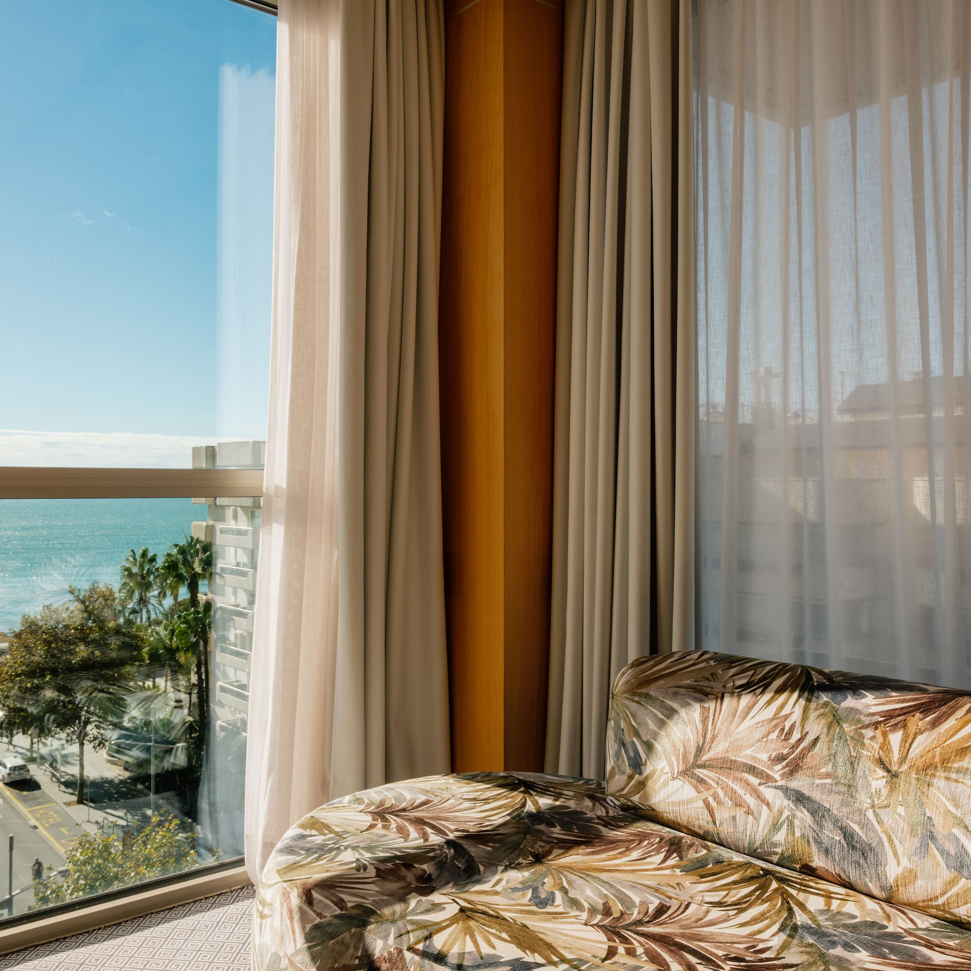 a couch in a room with a view of the ocean