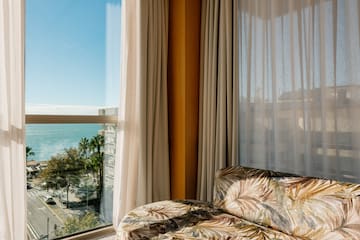 a couch in a room with a view of the ocean