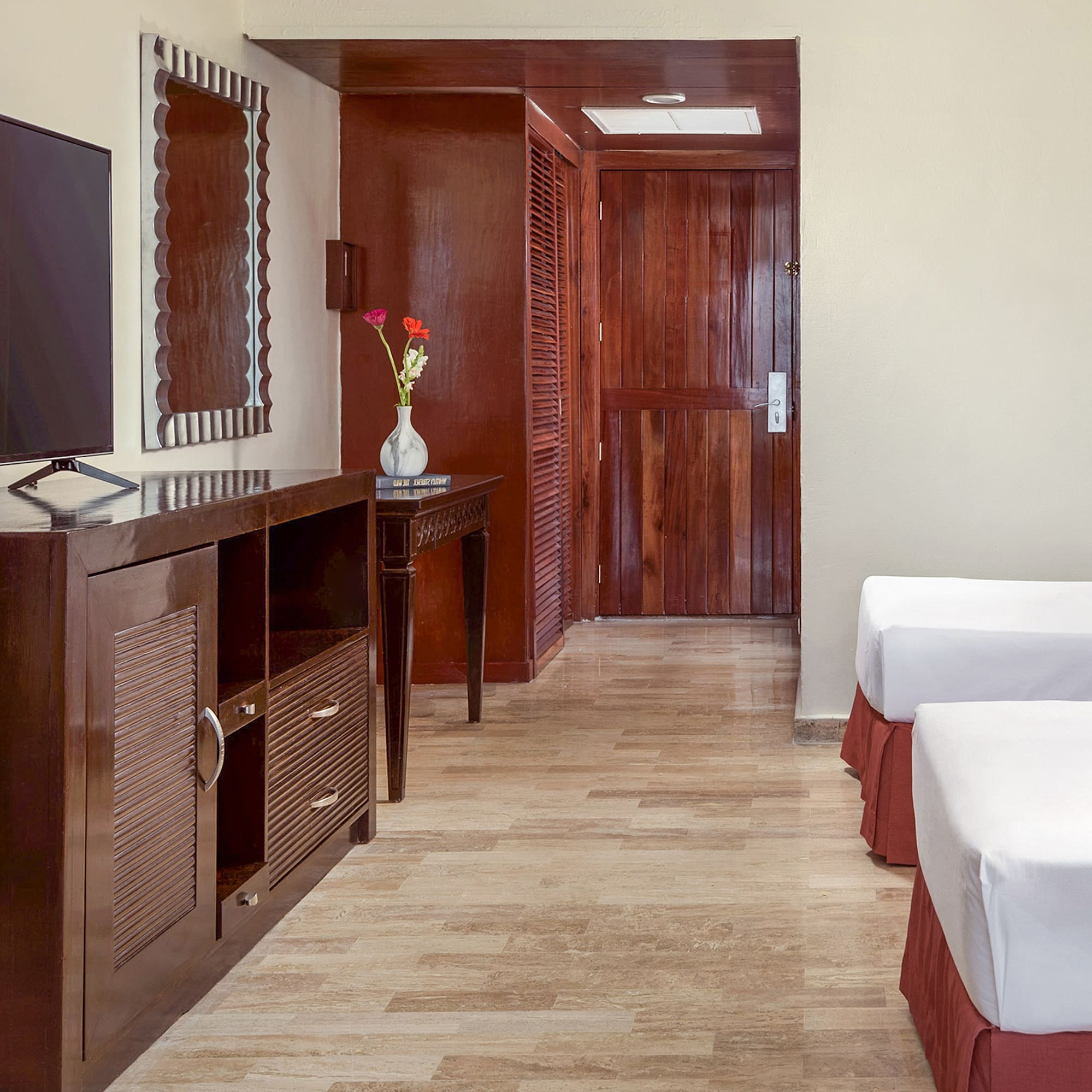 a room with two beds and a television