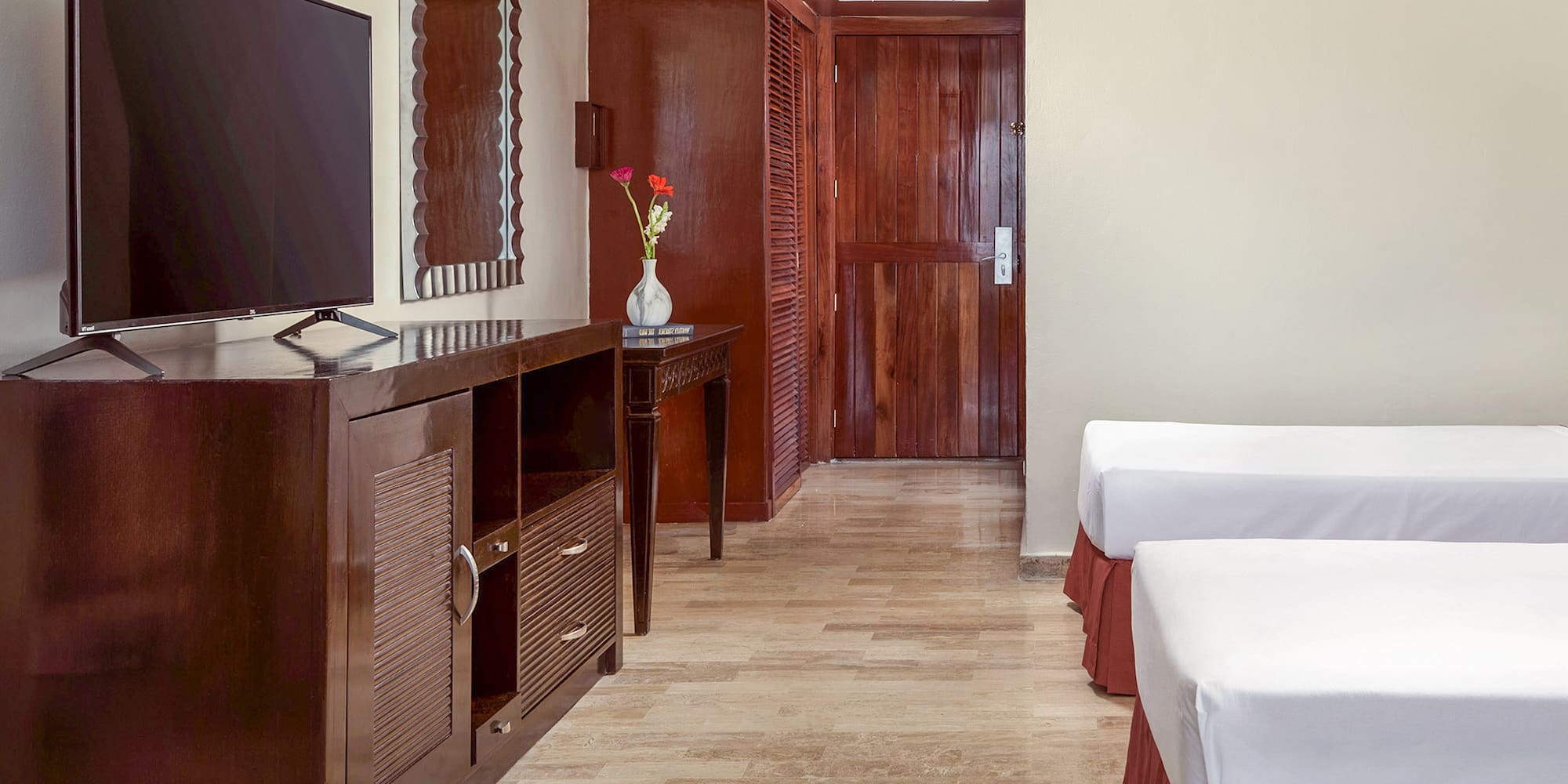 a room with two beds and a television