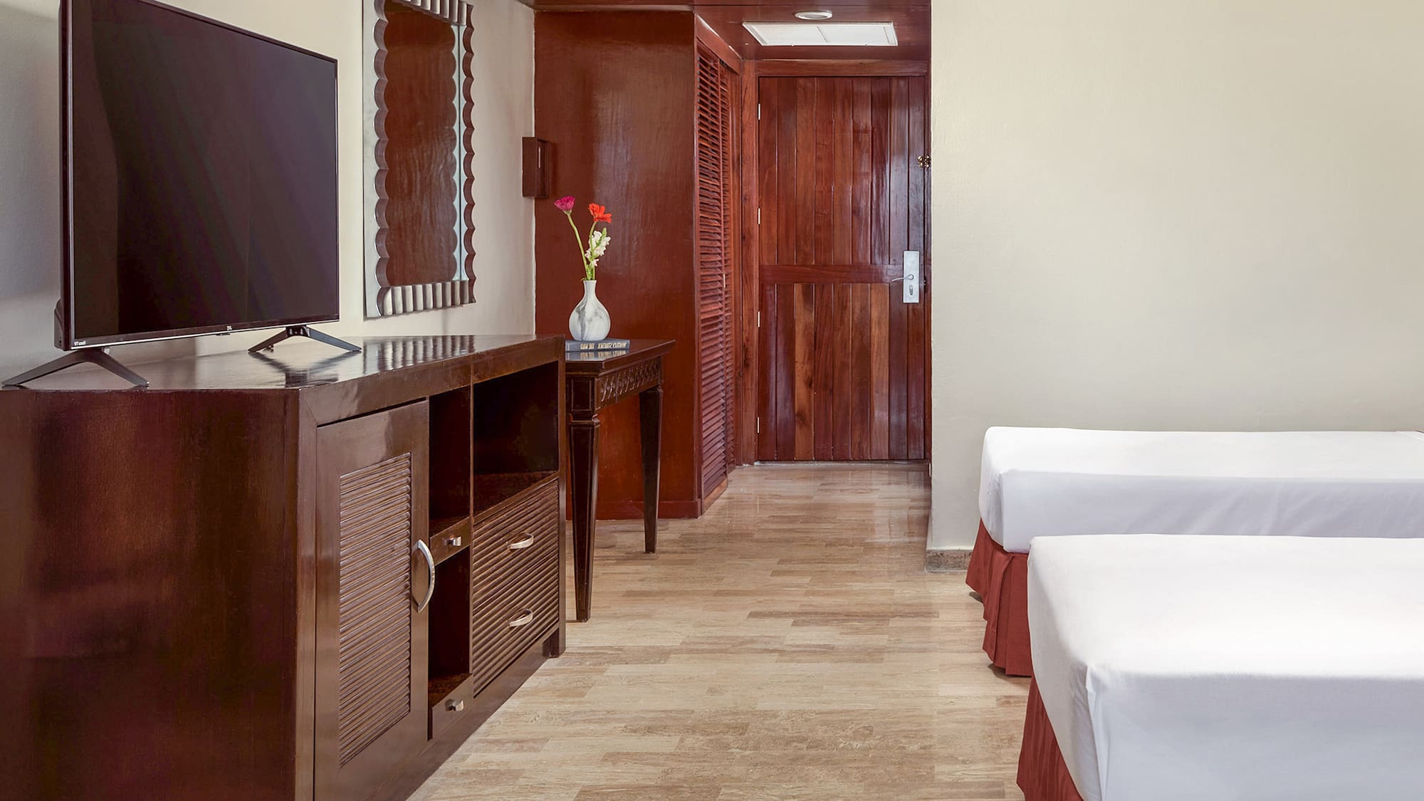 a room with two beds and a television