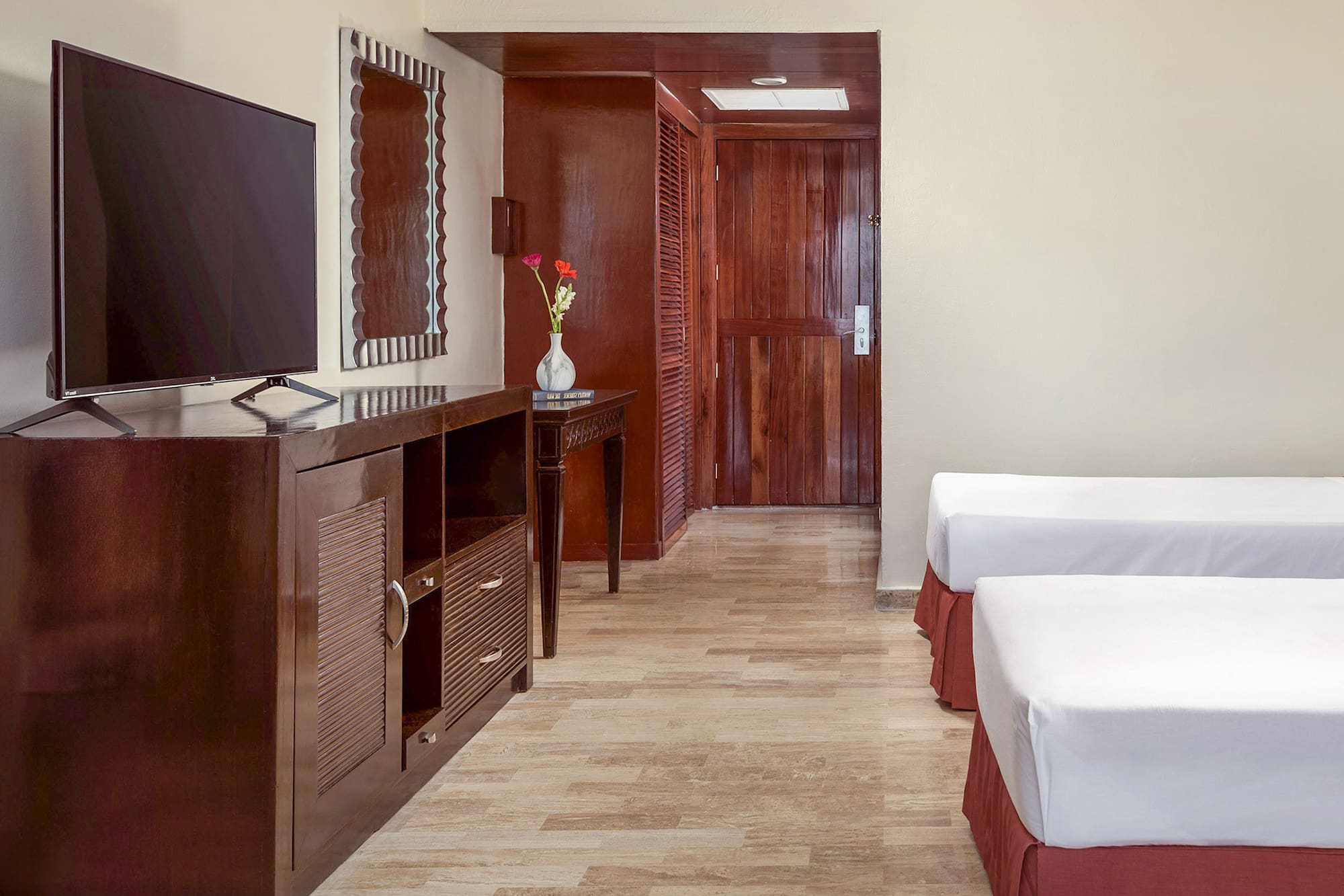 a room with two beds and a television