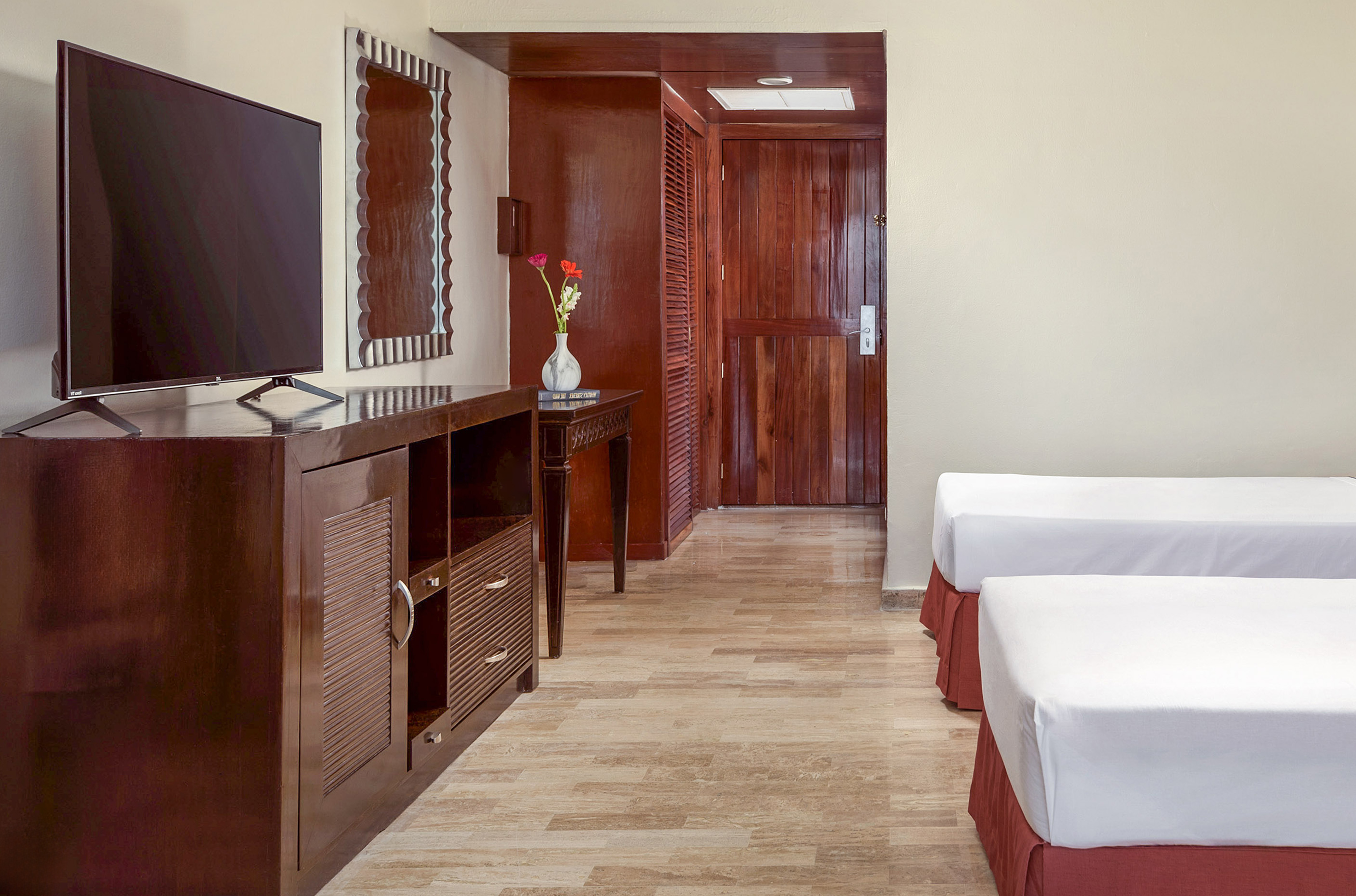 a room with two beds and a television