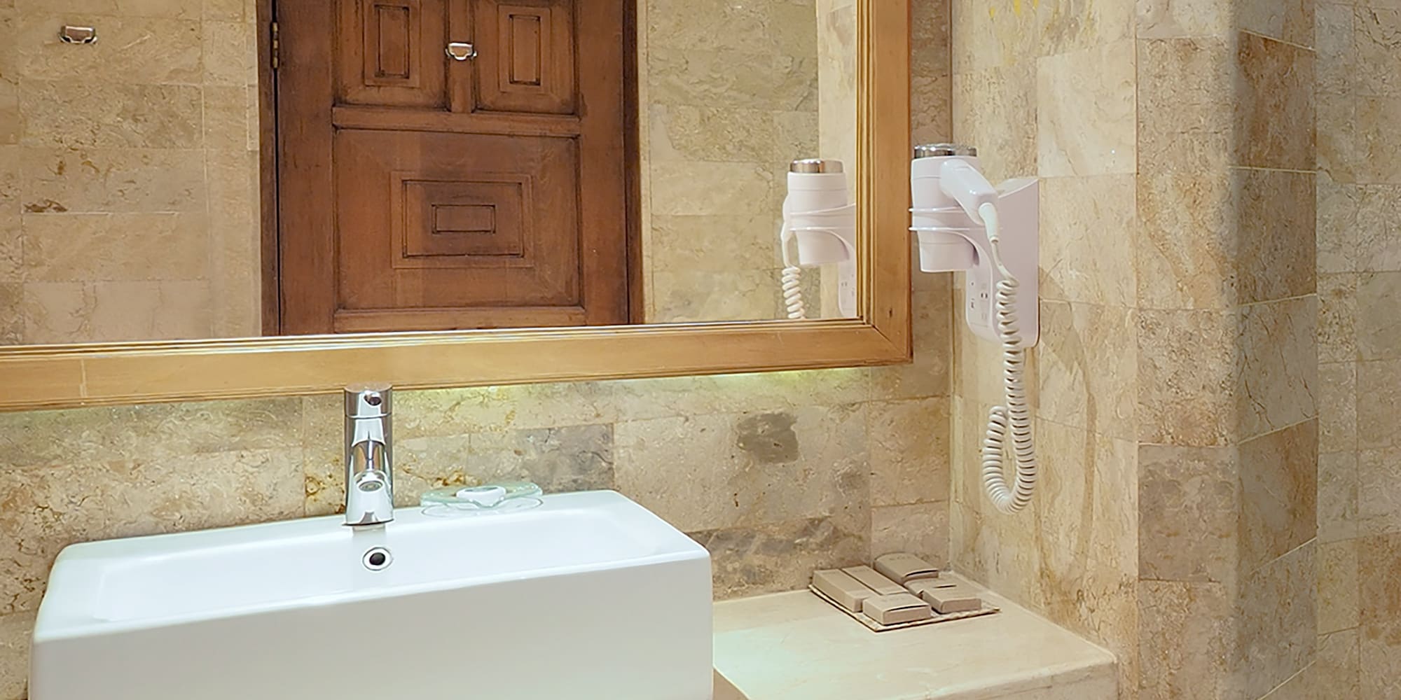 a bathroom with a mirror and sink