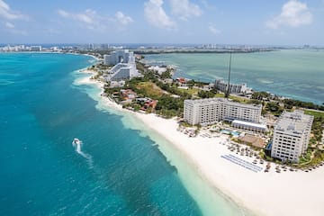 a beach with buildings and a body of water