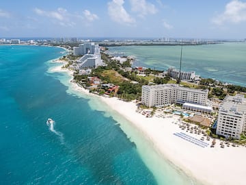 a beach with buildings and a body of water