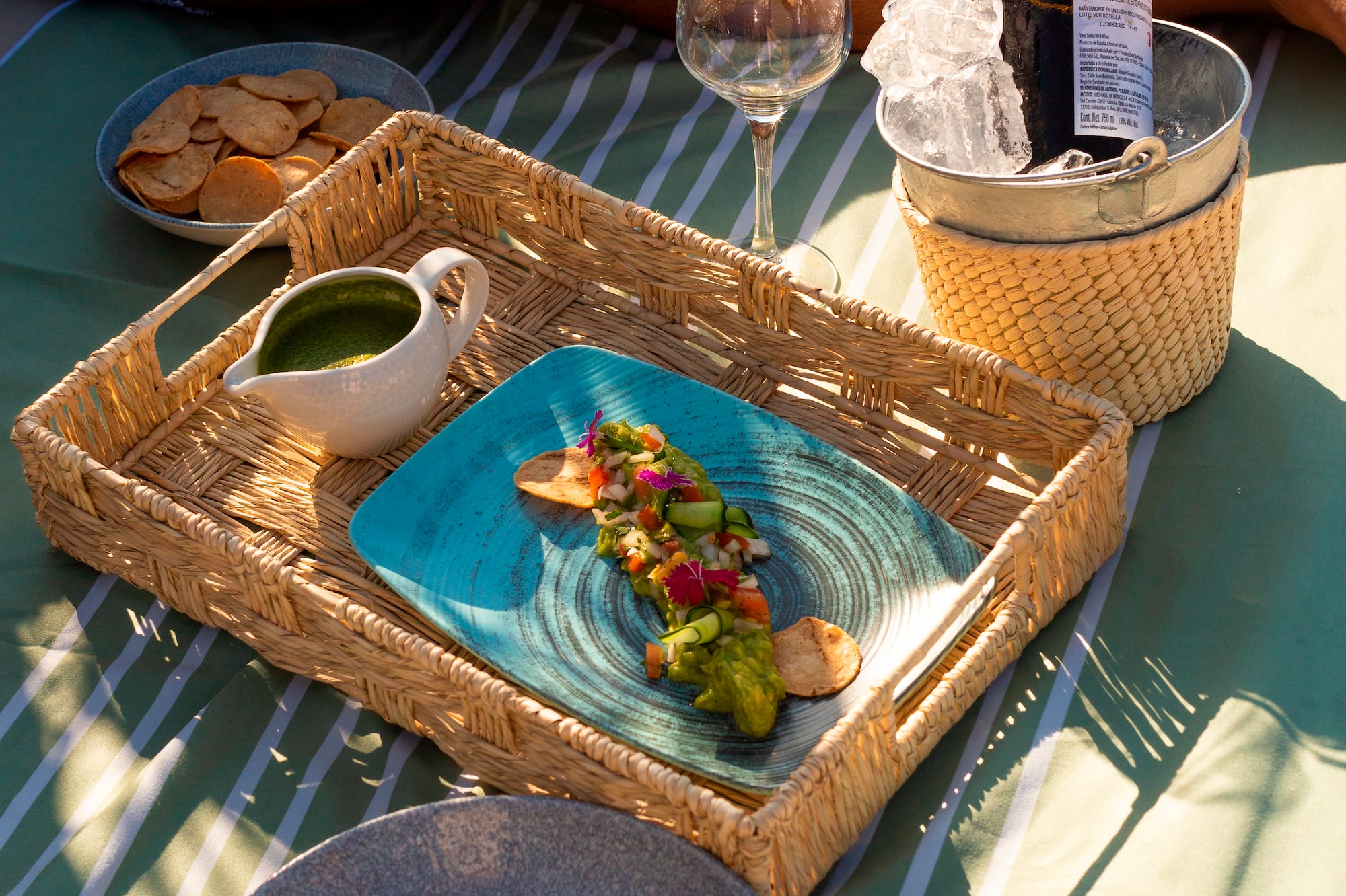 a picnic table with food and wine