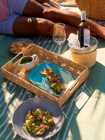 a picnic table with food and wine