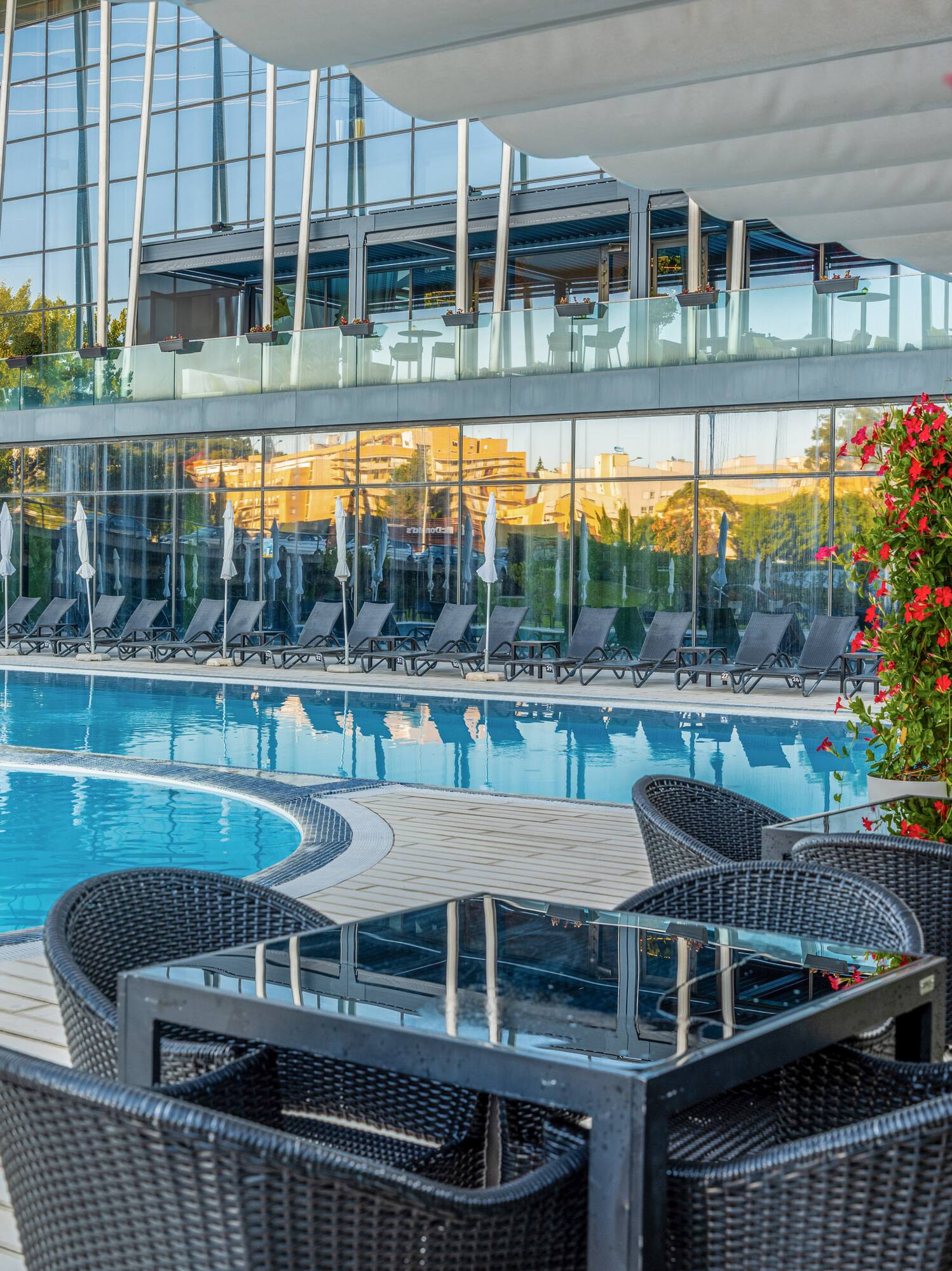 a pool with chairs and tables