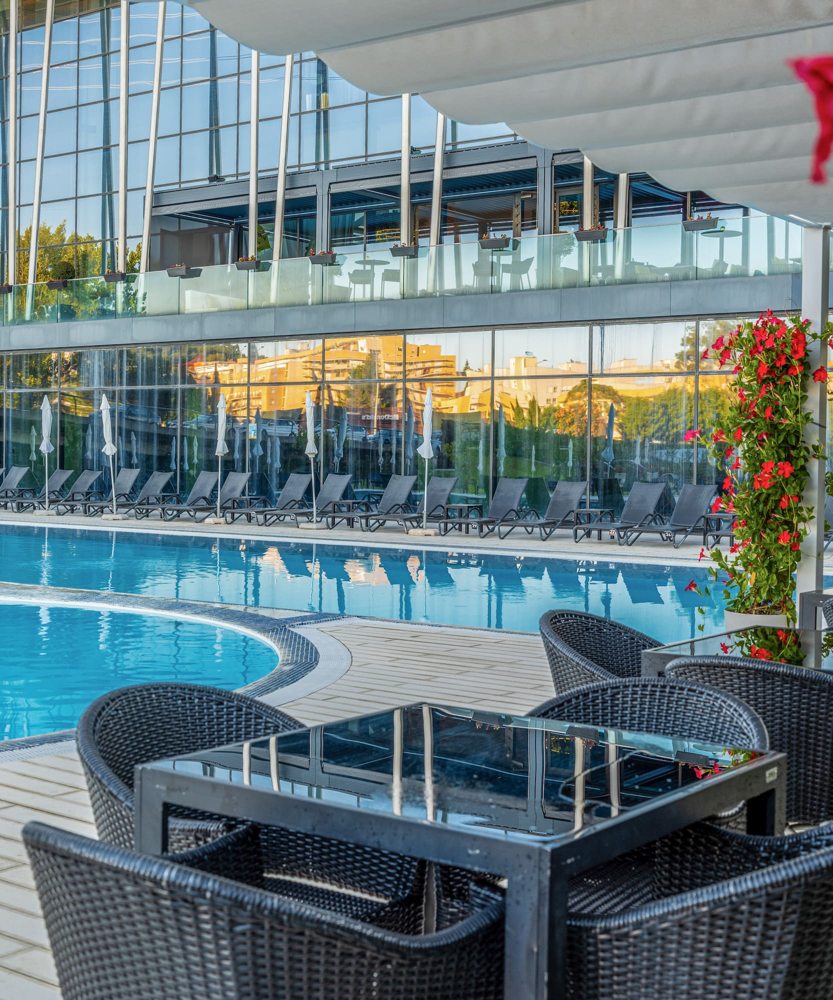 a pool with chairs and tables