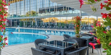 a pool with chairs and tables