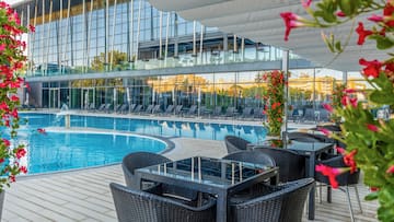 a pool with chairs and tables