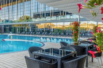 a pool with chairs and tables