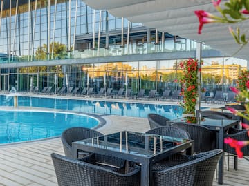 a pool with chairs and tables