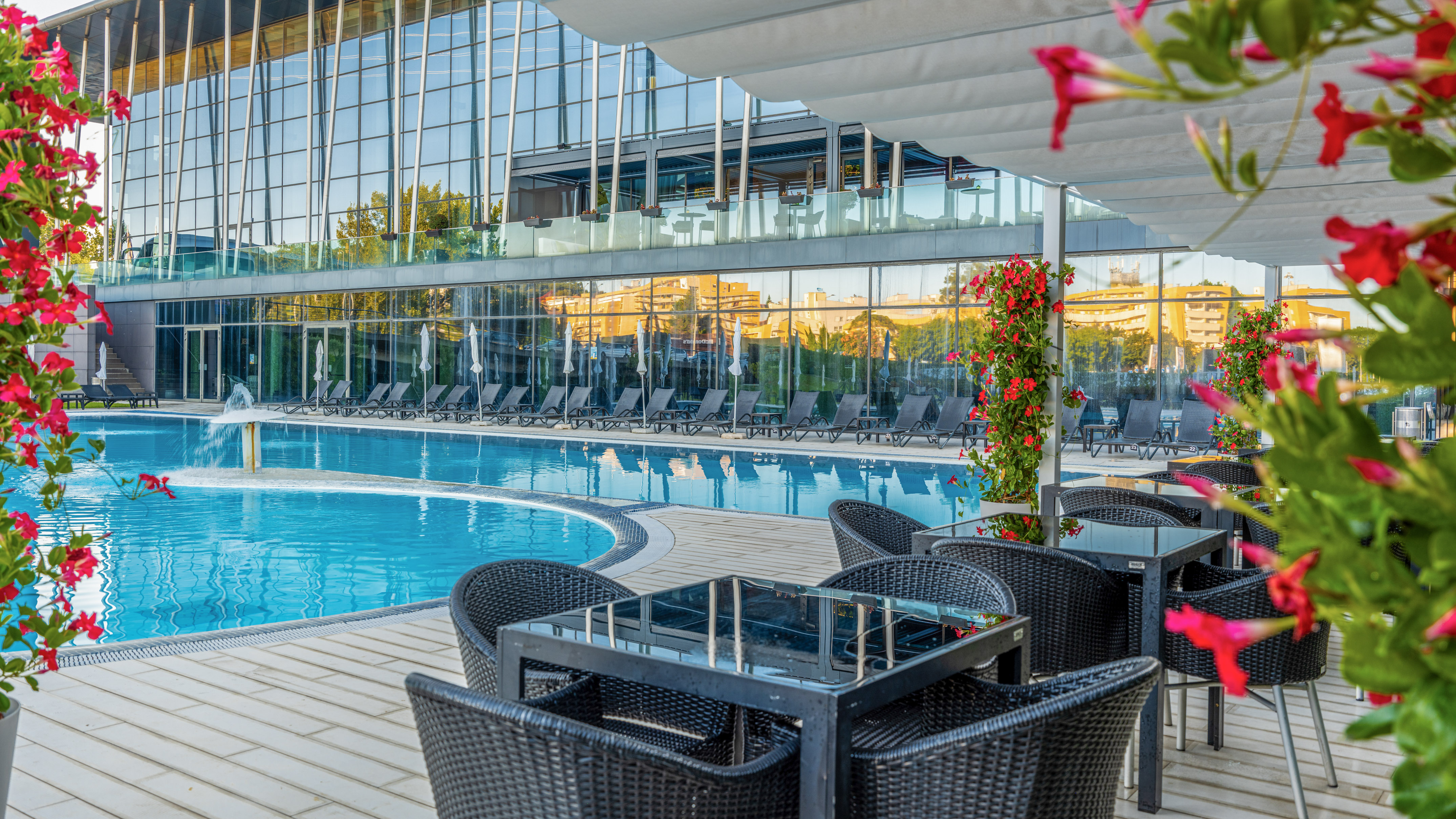 a pool with chairs and tables