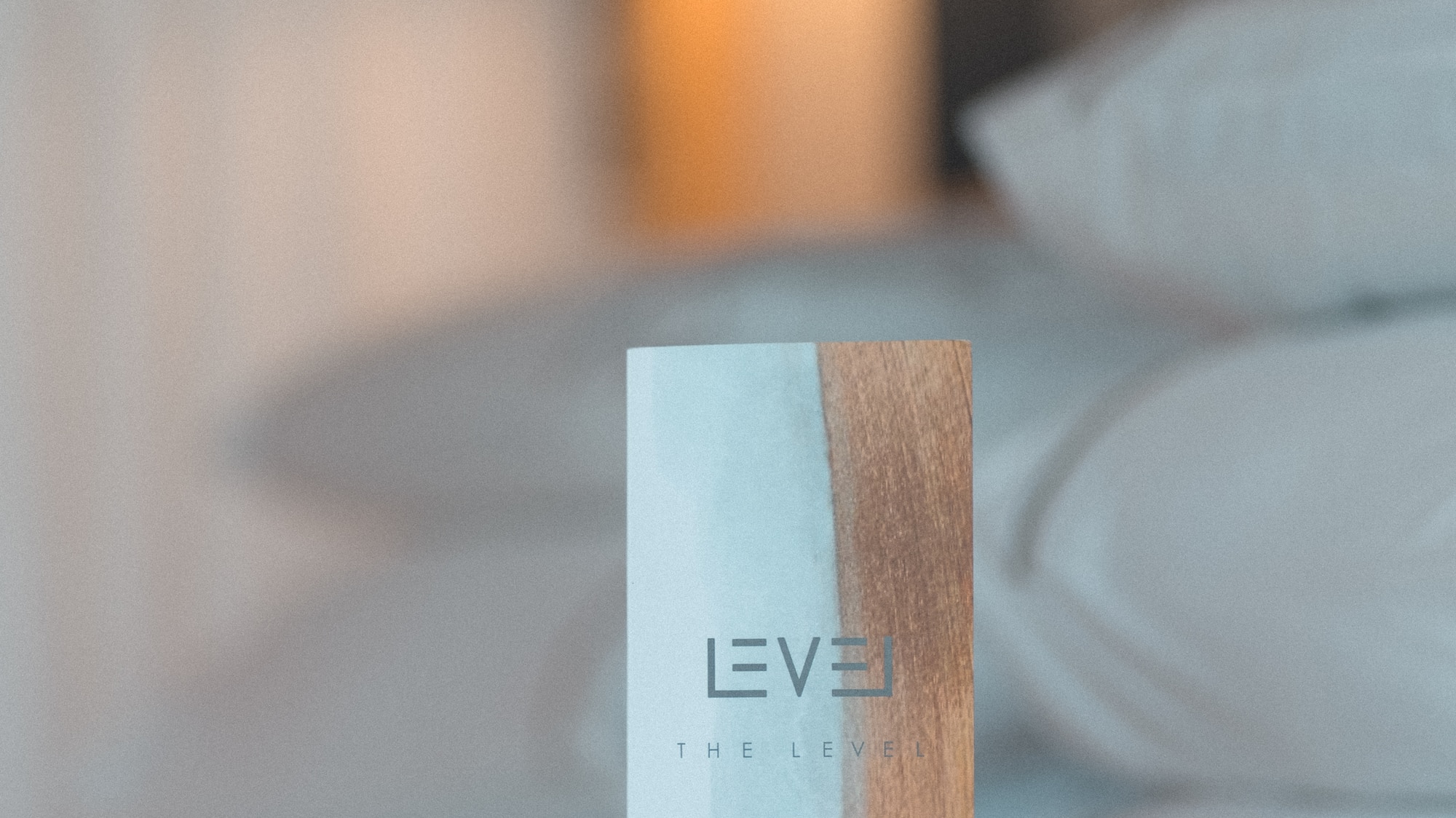 The Level pillow menu card on a luxury hotel bed.