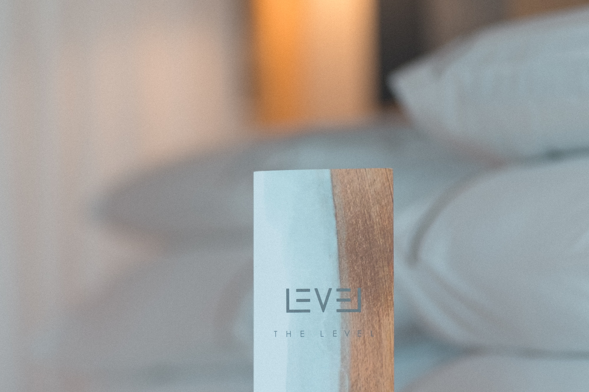 The Level pillow menu card on a luxury hotel bed.