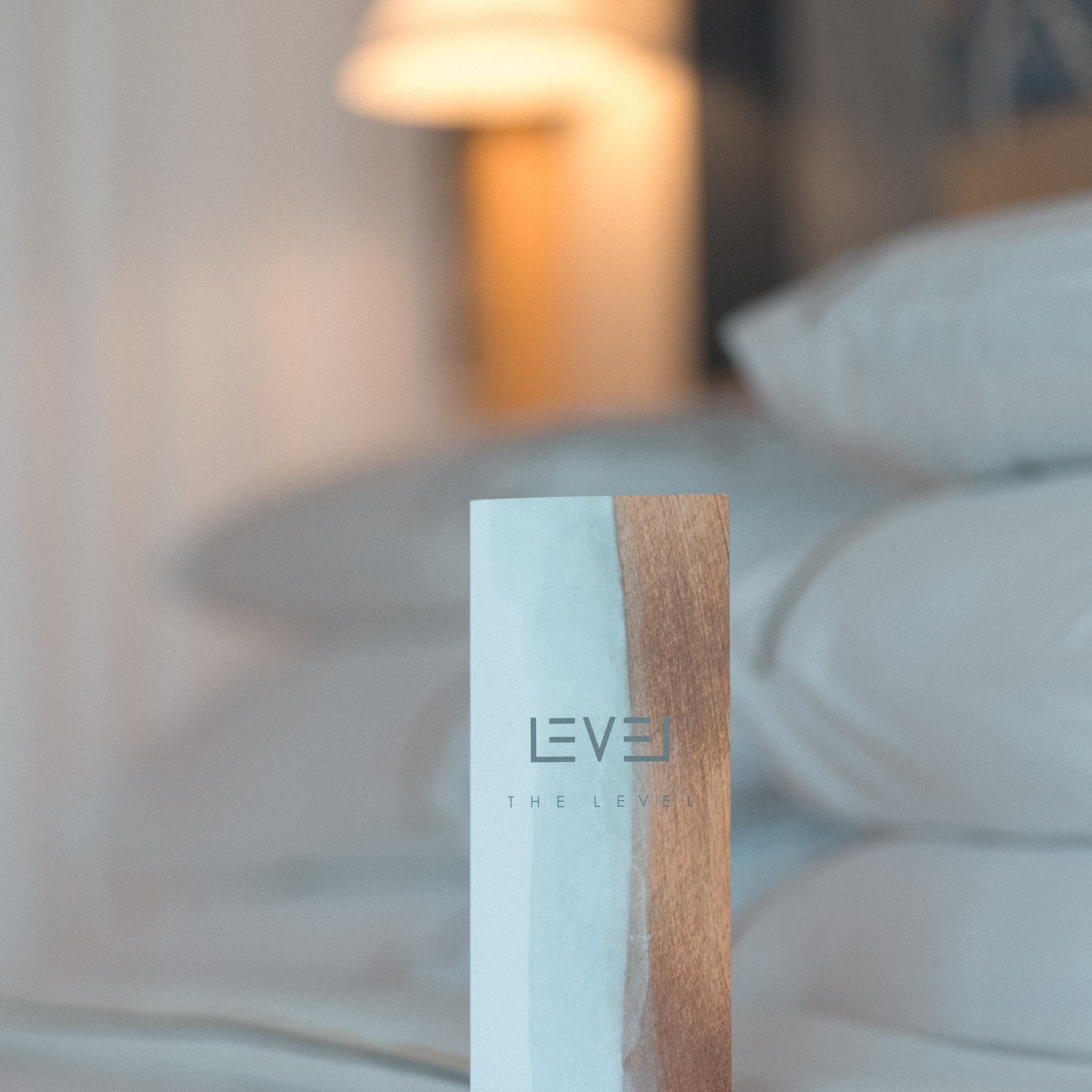 The Level pillow menu card on a luxury hotel bed.