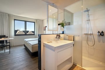 a bathroom with a shower and a bed