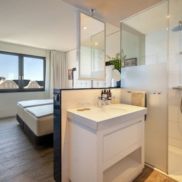 a bathroom with a shower and a bed