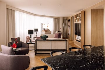 a living room with a table and chairs