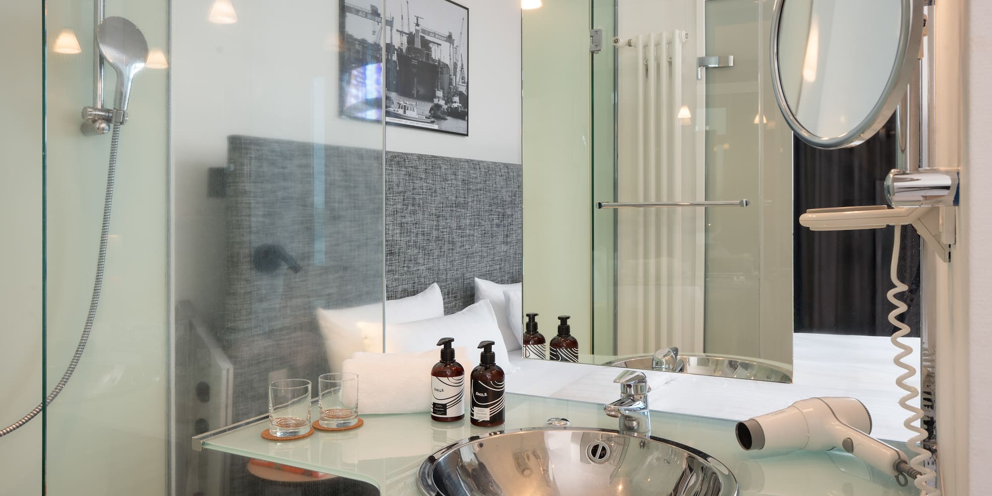 a bathroom with a glass shower and a mirror