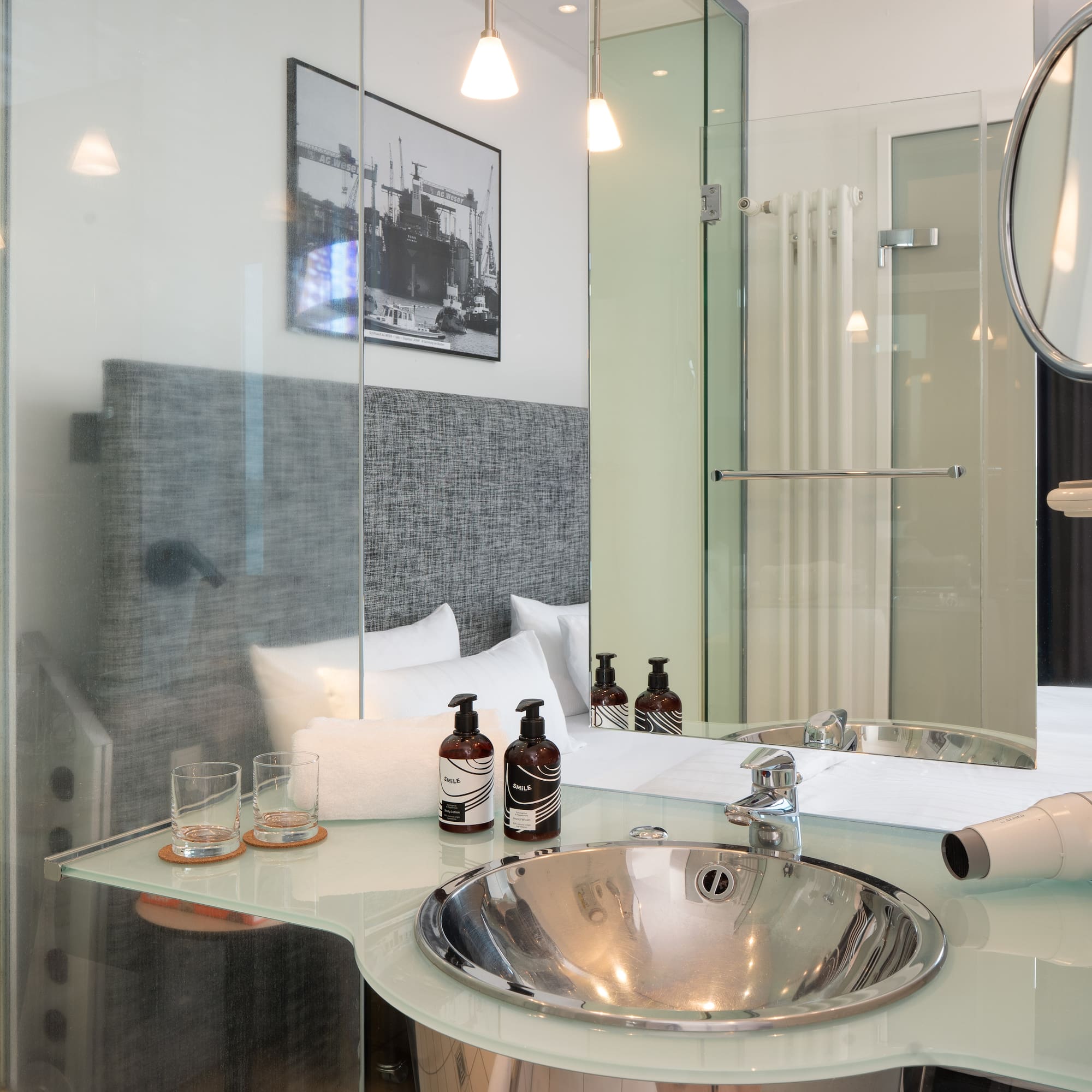 a bathroom with a glass shower and a mirror