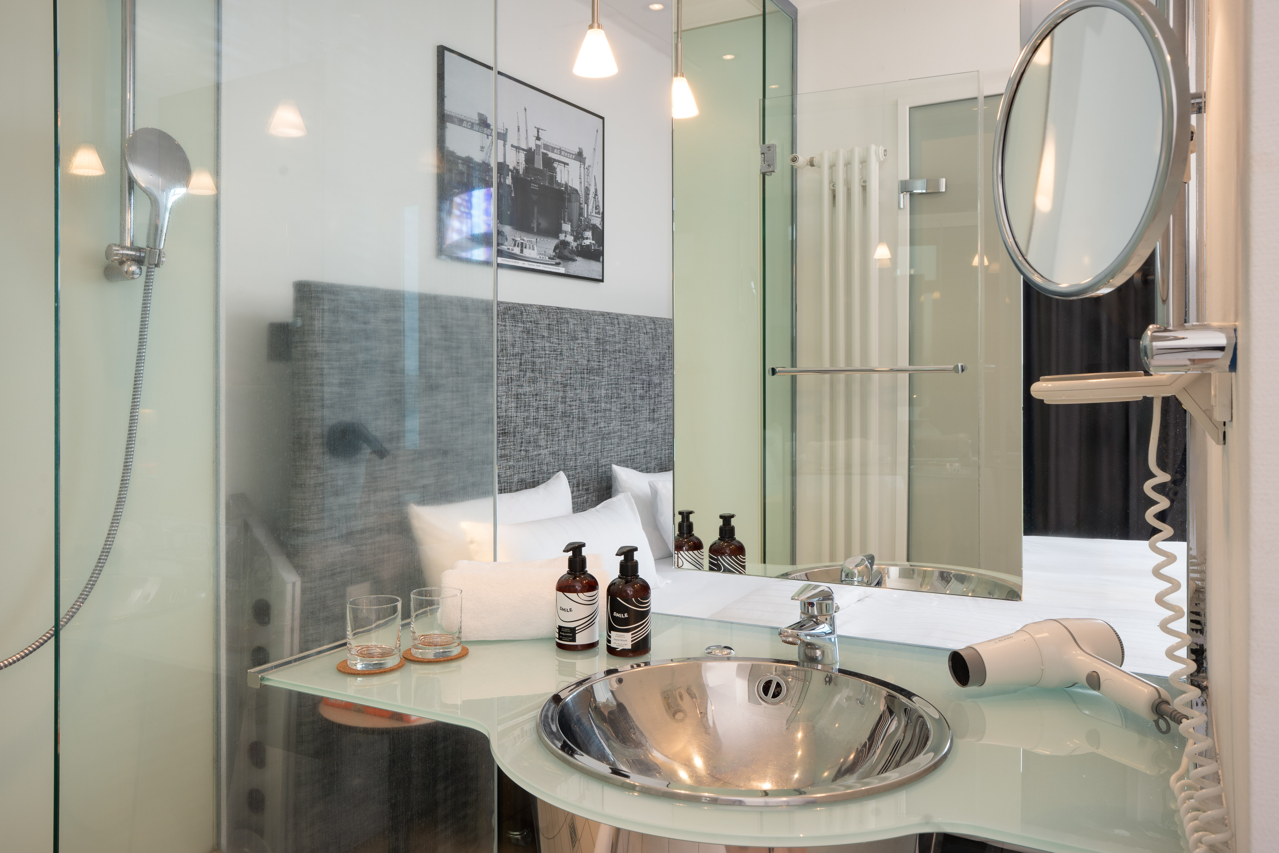 a bathroom with a glass shower and a mirror