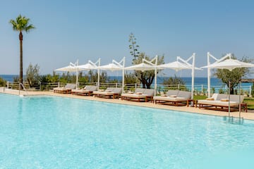a pool with lounge chairs and umbrellas