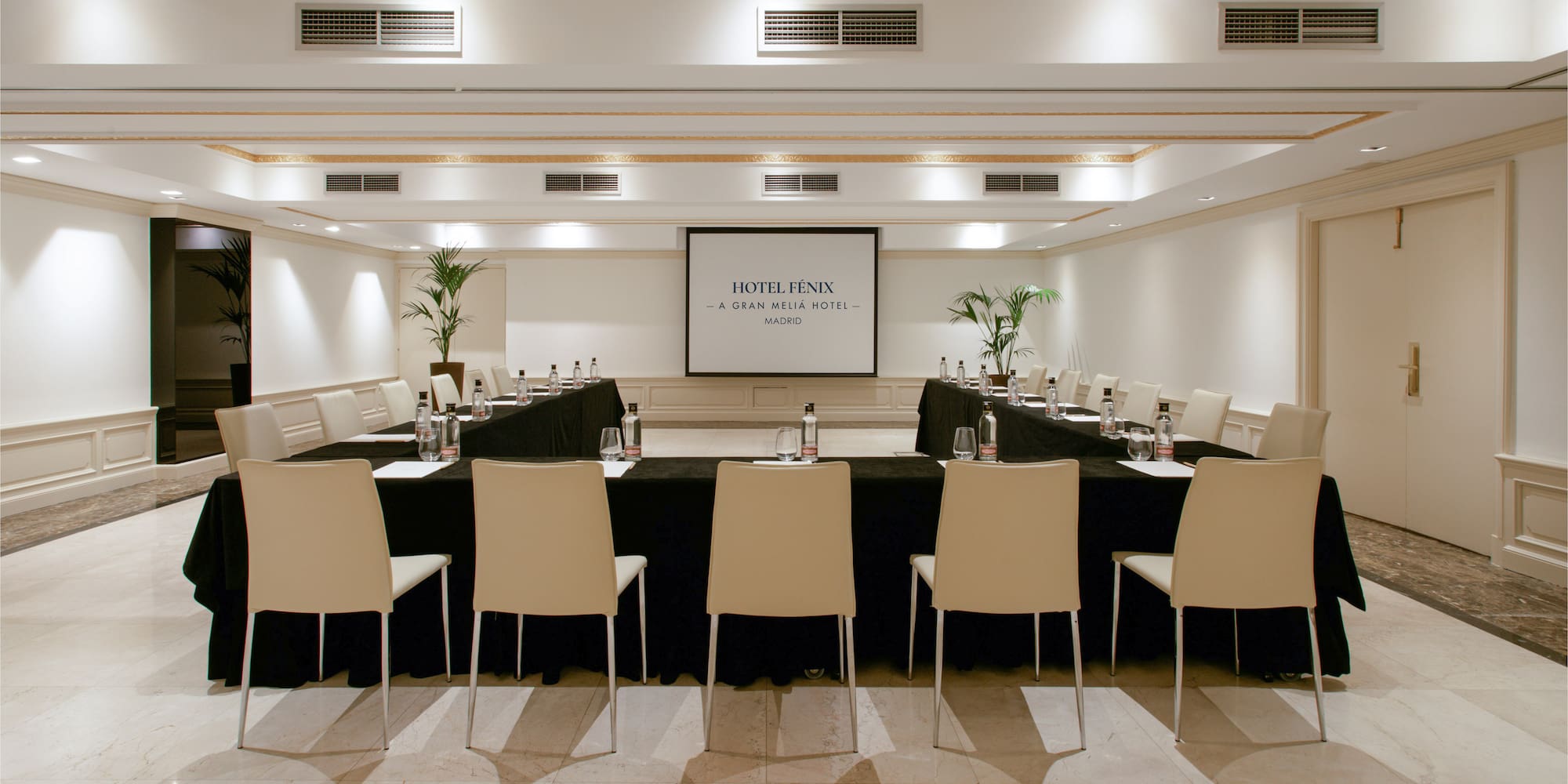 a room with a black table and chairs