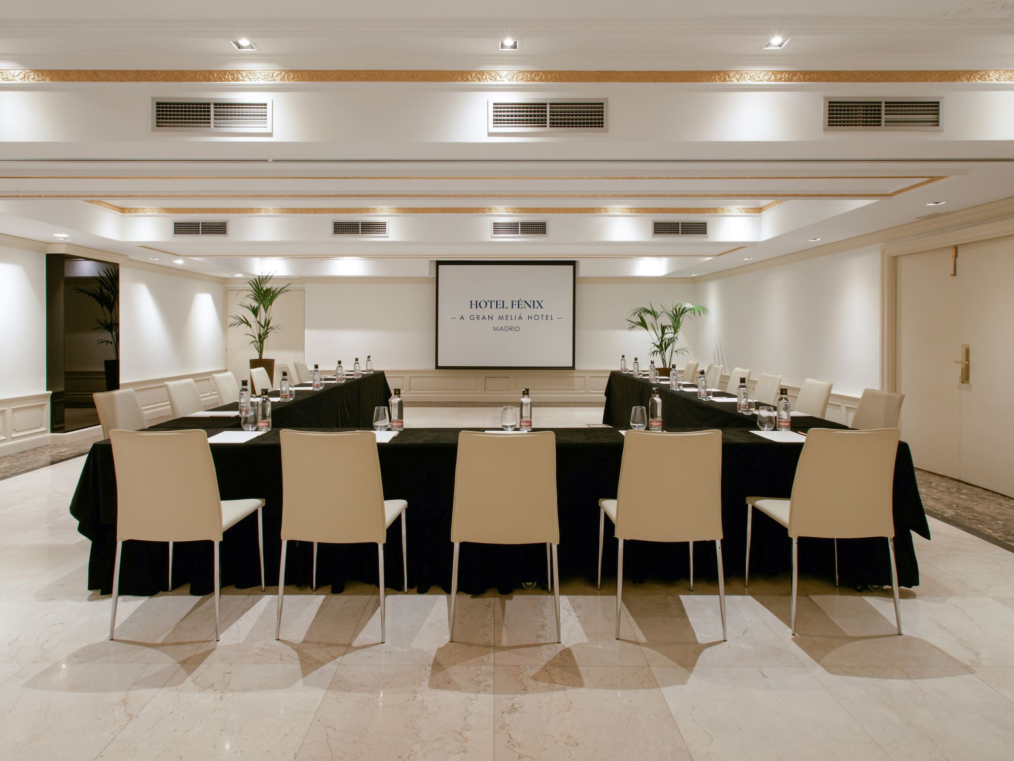 a room with a black table and chairs