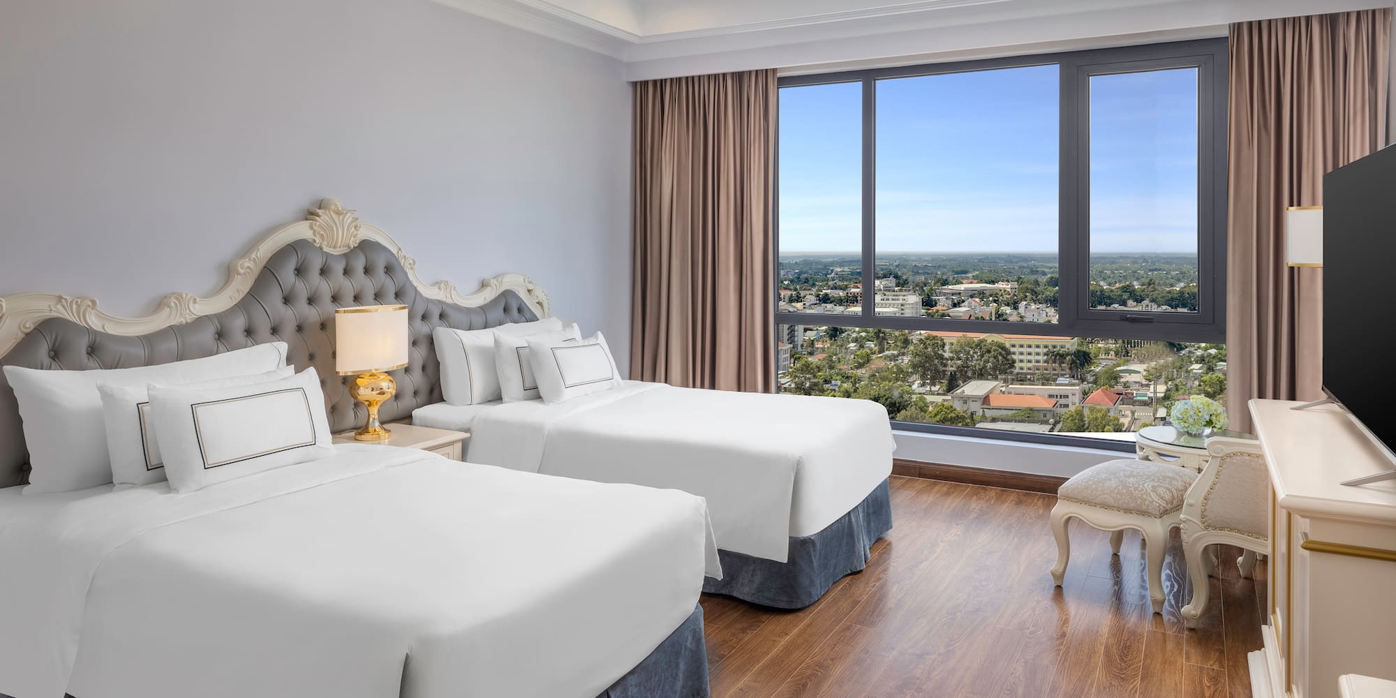 a room with two beds and a window