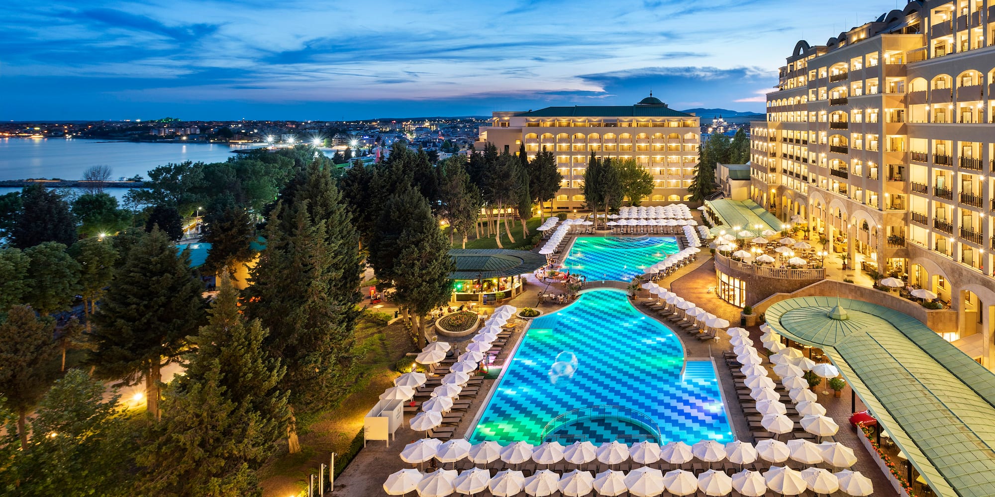 a pool and umbrellas in a hotel