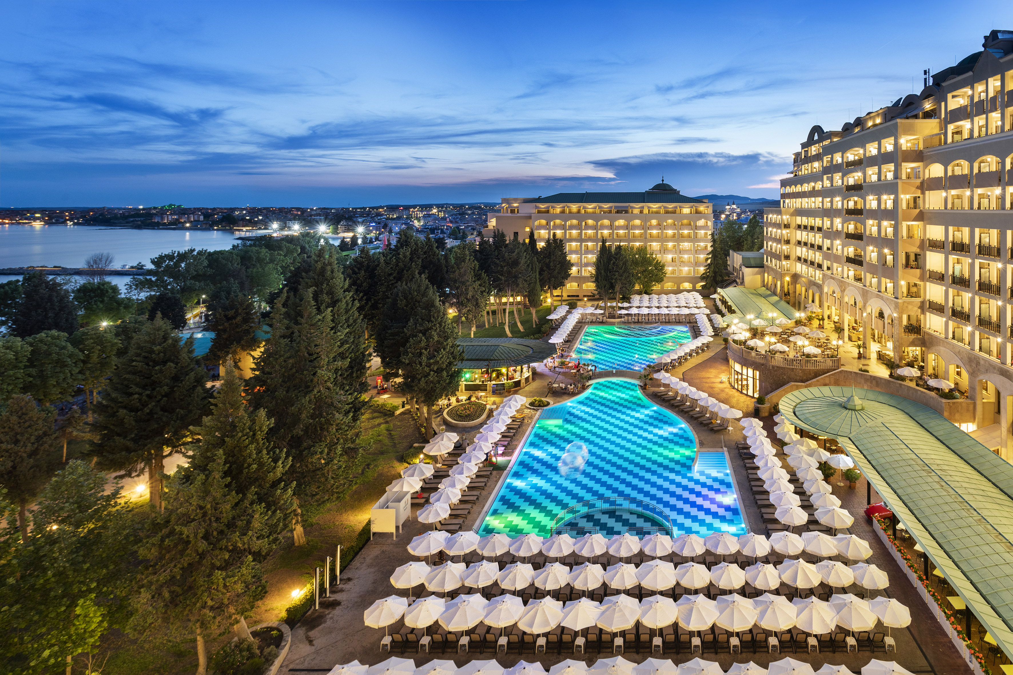 a pool and umbrellas in a hotel