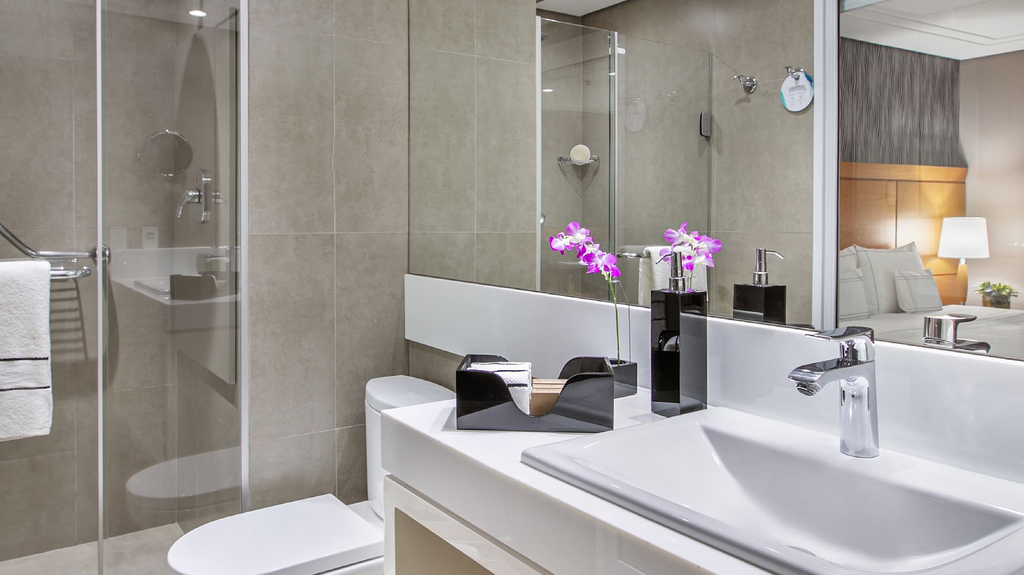 a bathroom with a glass shower door and sink
