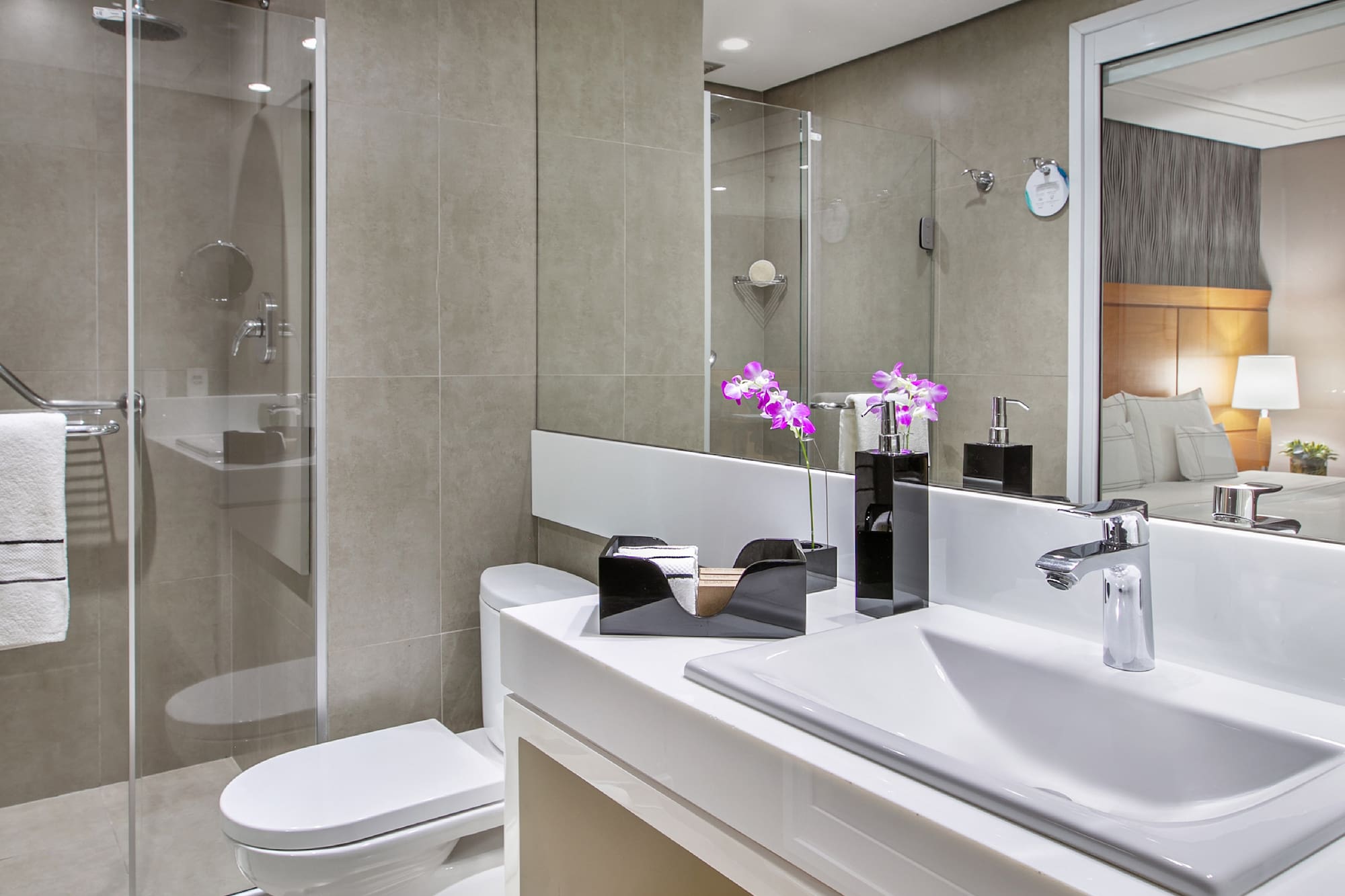 a bathroom with a glass shower door and sink