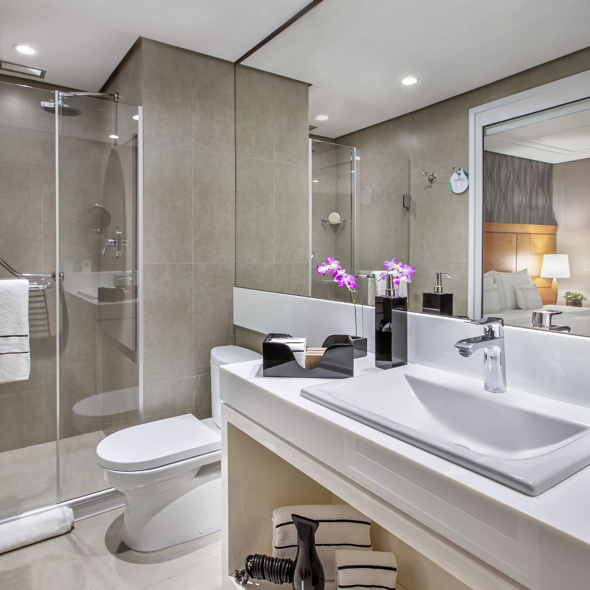 a bathroom with a glass shower door and sink