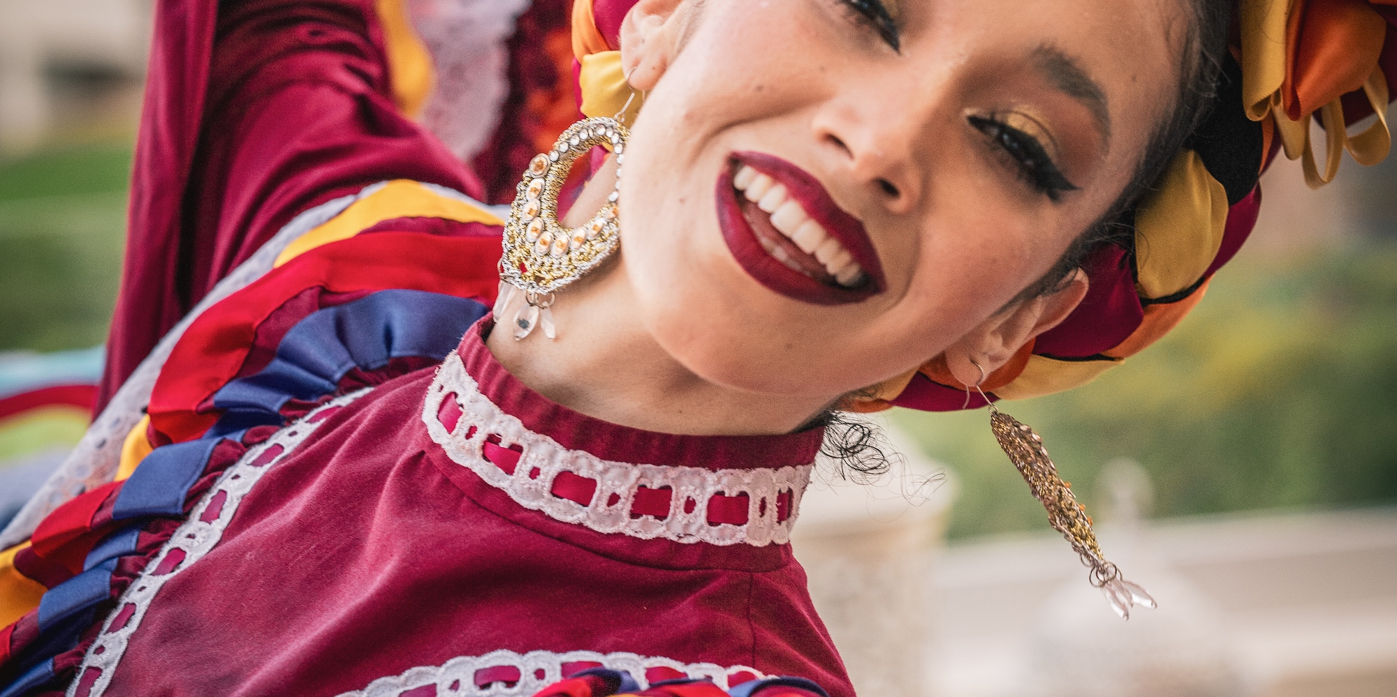 a woman wearing a colorful dress and smiling