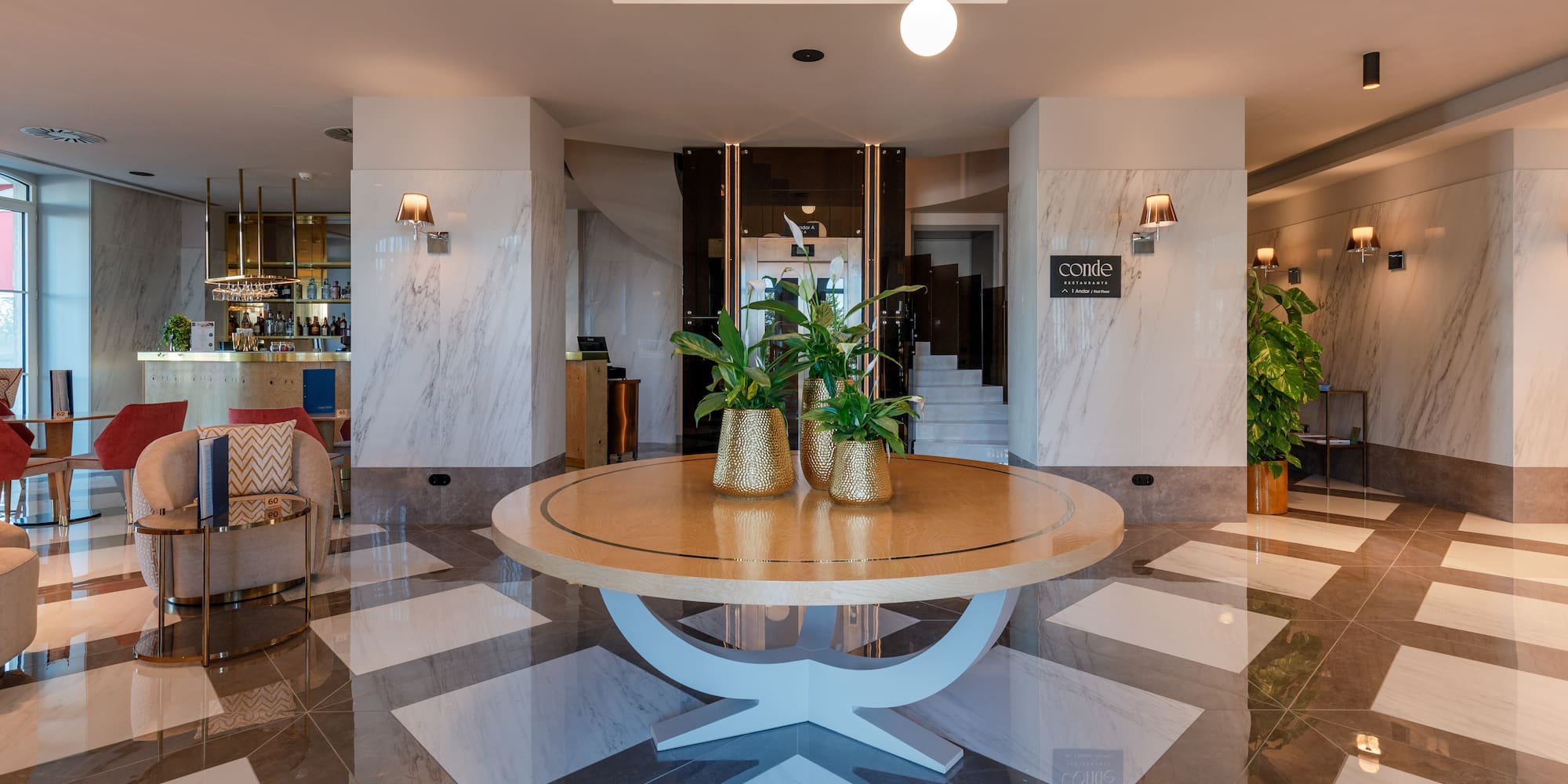 a room with a round table and a couch and a chair