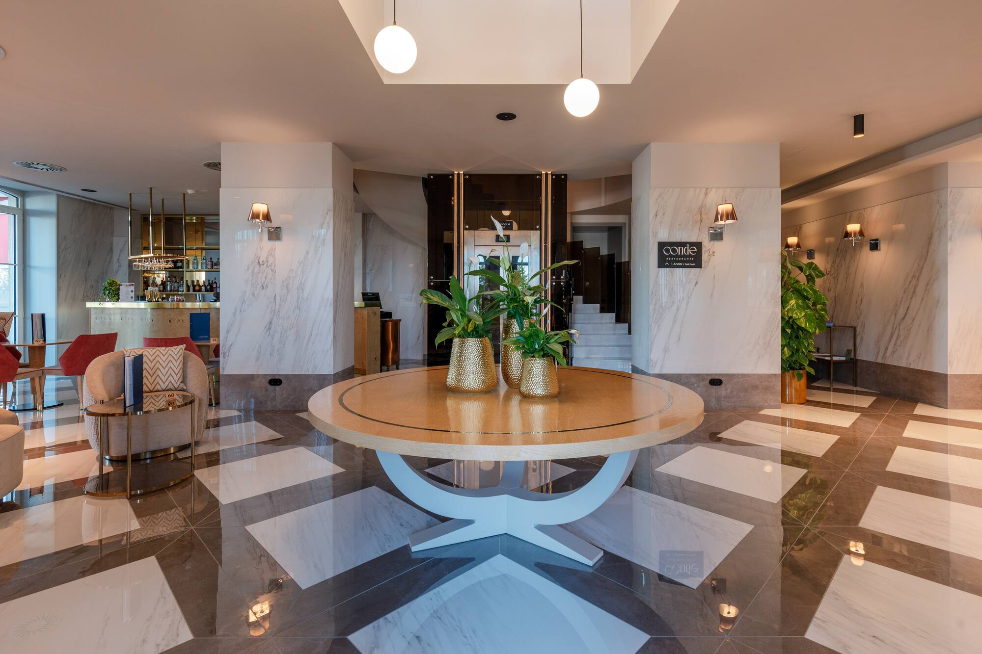 a room with a round table and a couch and a chair