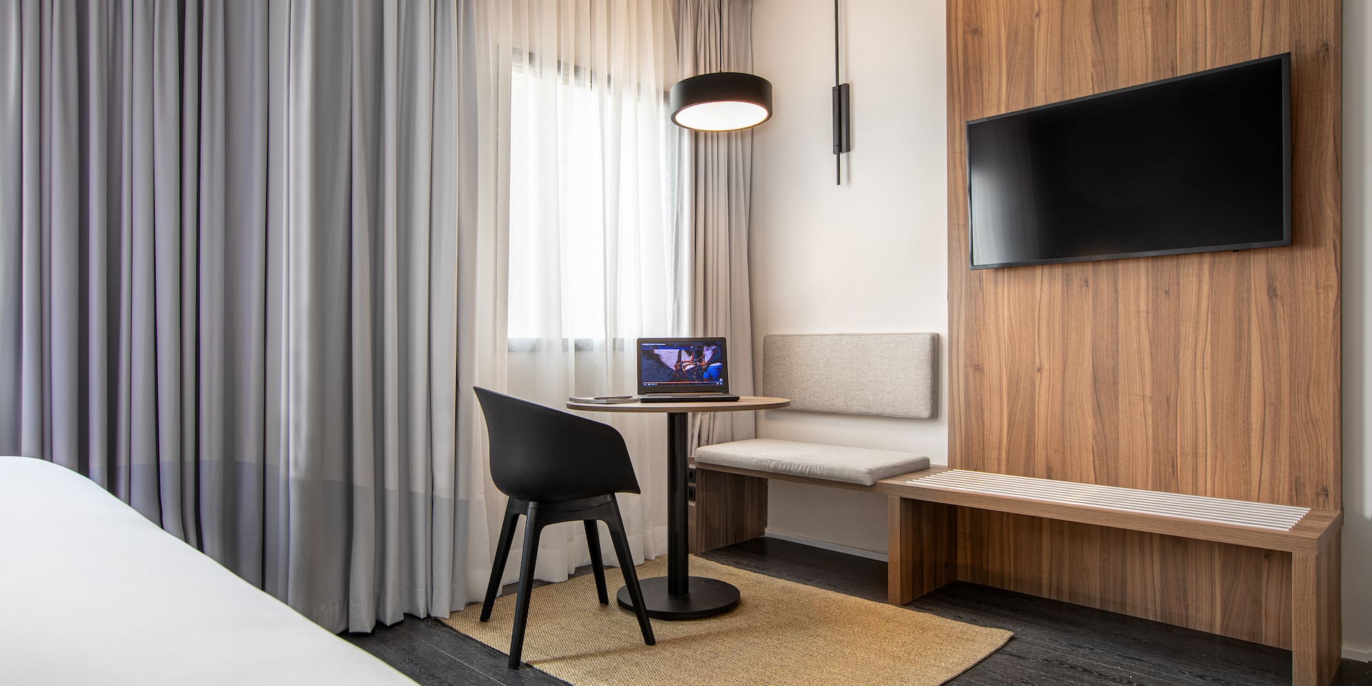 a room with a table and chairs and a tv