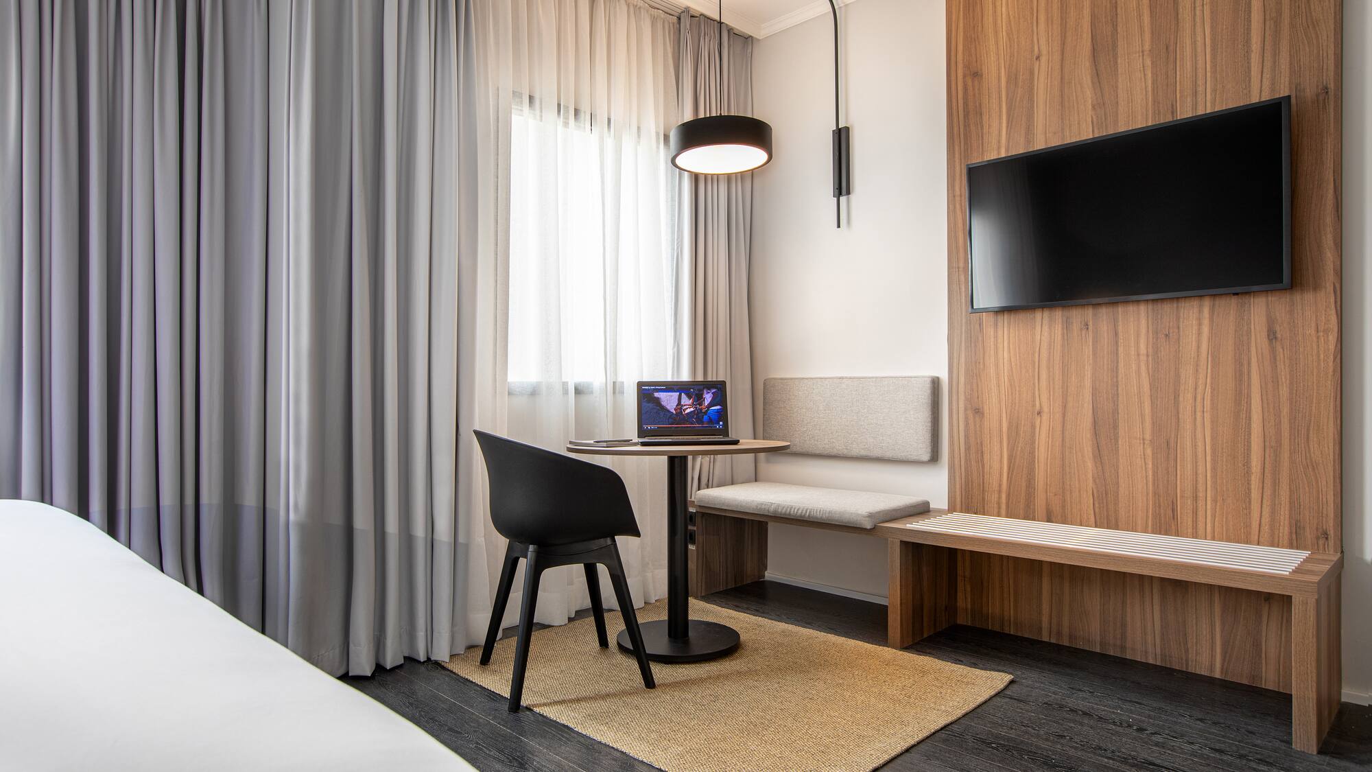 a room with a table and chairs and a tv