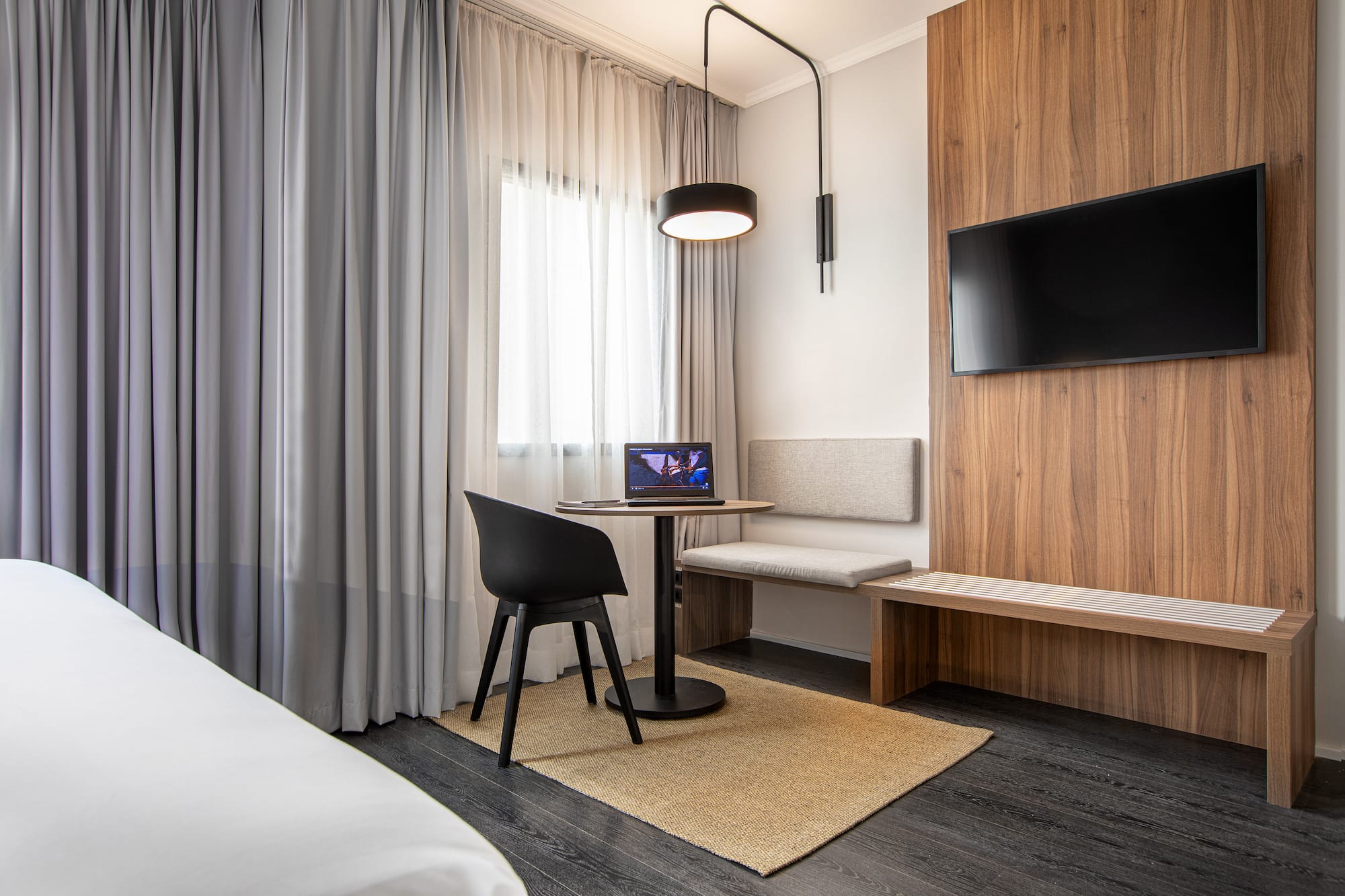 a room with a table and chairs and a tv