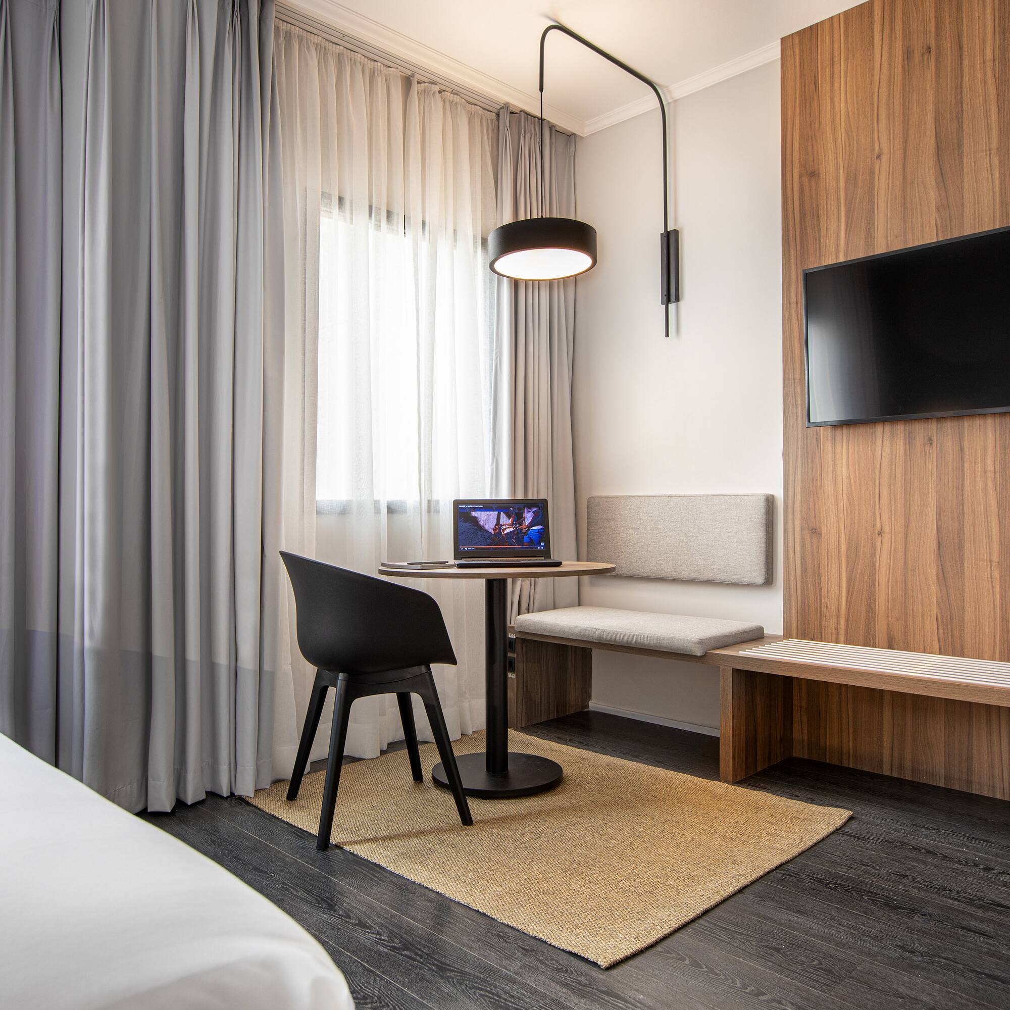 a room with a table and chairs and a tv