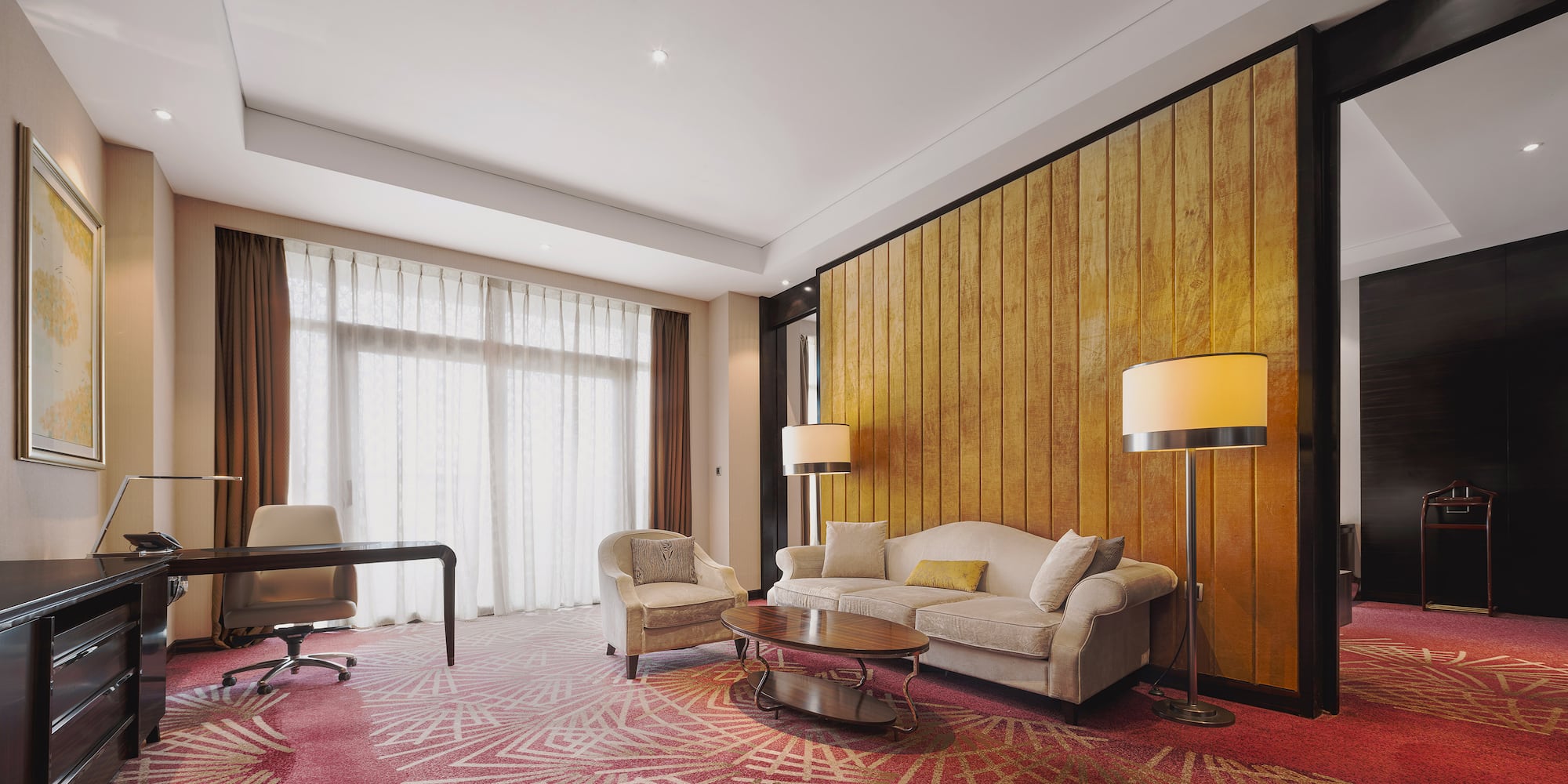 a room with a couch and chairs