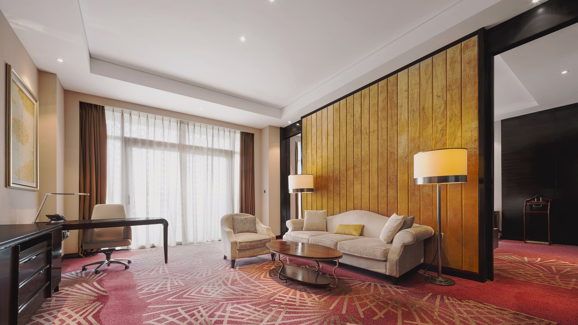 a room with a couch and chairs